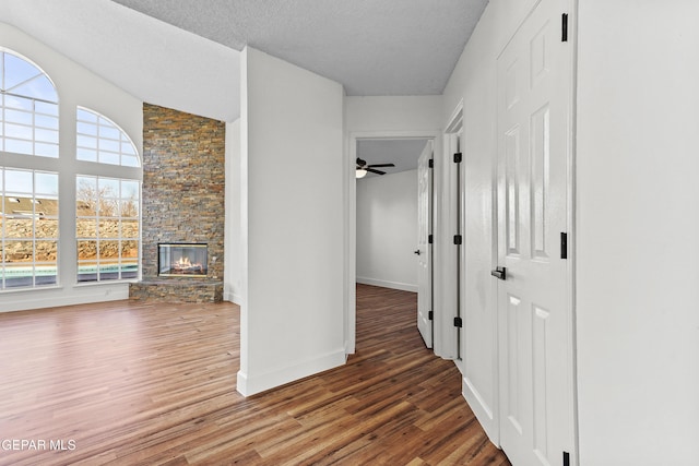 hall featuring hardwood / wood-style floors and a textured ceiling