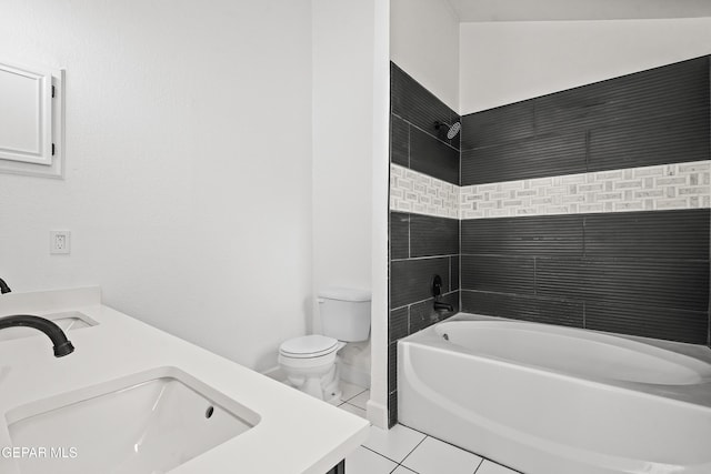 full bathroom with tiled shower / bath combo, vanity, tile patterned floors, and toilet