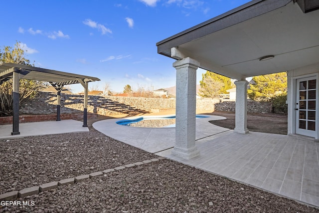 view of patio featuring a fenced in pool and a pergola