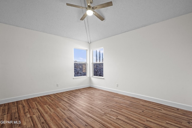 spare room with lofted ceiling, hardwood / wood-style flooring, a textured ceiling, and ceiling fan