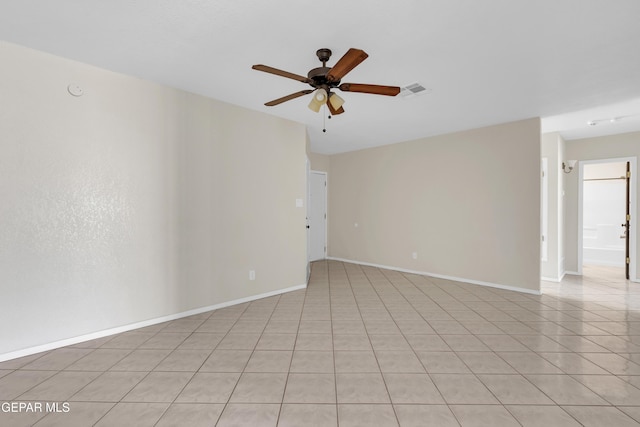 empty room featuring light tile patterned floors and ceiling fan