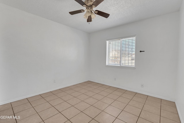 spare room with a textured ceiling and ceiling fan