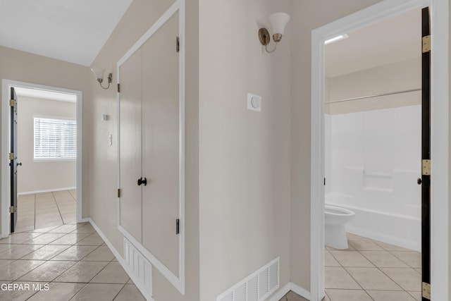 corridor featuring light tile patterned flooring