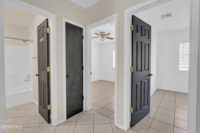 hall with light tile patterned floors