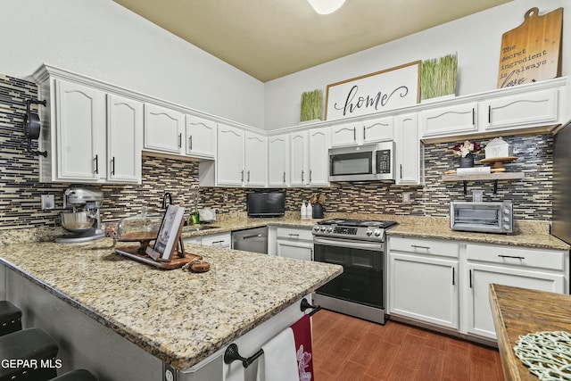 kitchen featuring light stone counters, white cabinets, and appliances with stainless steel finishes