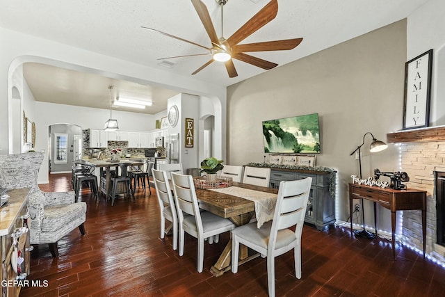 dining space featuring dark hardwood / wood-style floors and a fireplace