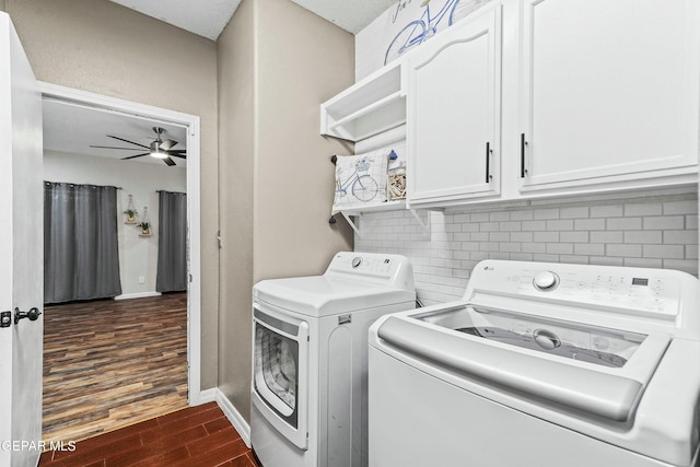 clothes washing area with ceiling fan, cabinets, dark hardwood / wood-style flooring, and separate washer and dryer