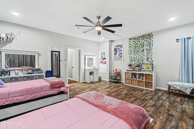 bedroom featuring ceiling fan, dark hardwood / wood-style floors, and a textured ceiling