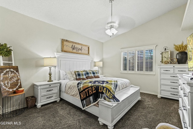 bedroom with lofted ceiling, dark carpet, and a textured ceiling