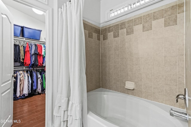 bathroom featuring hardwood / wood-style flooring and shower / tub combo with curtain