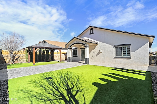 exterior space with a gazebo and a front lawn