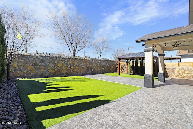 view of yard with a gazebo, ceiling fan, and a patio