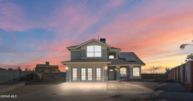 view of front of property featuring french doors and solar panels