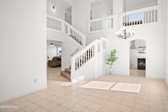 stairway featuring an inviting chandelier and tile patterned flooring