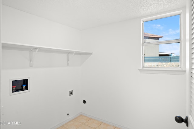 laundry room with washer hookup, electric dryer hookup, and a textured ceiling