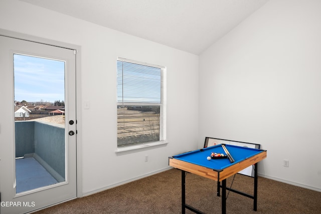 game room featuring dark colored carpet, vaulted ceiling, and a wealth of natural light