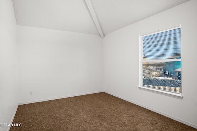 carpeted empty room with lofted ceiling with beams