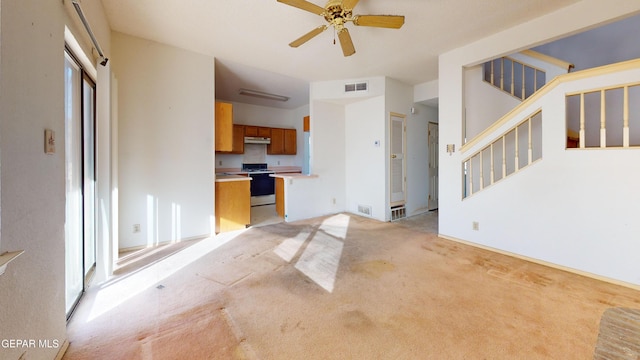 unfurnished living room with light carpet and ceiling fan