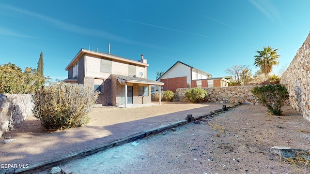 back of property with a patio