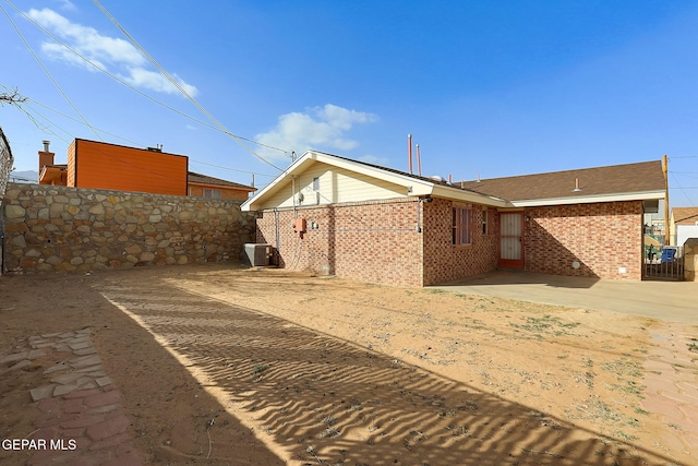 rear view of property featuring a patio and central air condition unit