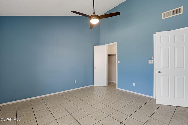 spare room featuring high vaulted ceiling and ceiling fan