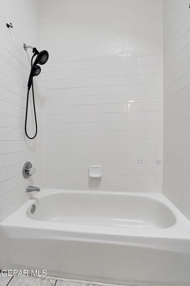 bathroom featuring tiled shower / bath