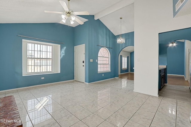 foyer entrance featuring ceiling fan with notable chandelier, light tile patterned floors, and beam ceiling