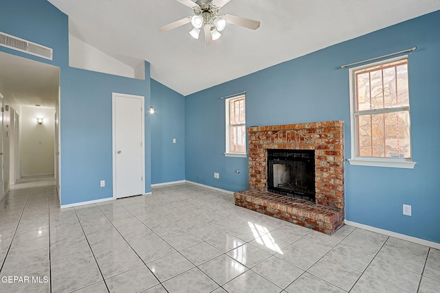 unfurnished living room with lofted ceiling, light tile patterned floors, a brick fireplace, and ceiling fan