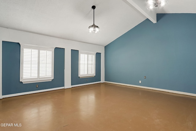 spare room with concrete flooring and vaulted ceiling with beams