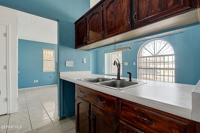 kitchen with sink and light tile patterned floors