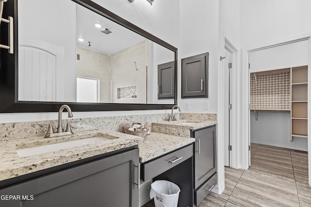 bathroom with vanity and a shower