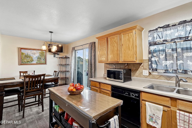 kitchen with decorative light fixtures, dishwasher, sink, decorative backsplash, and light brown cabinets