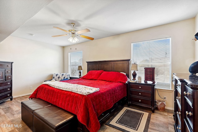 bedroom with ceiling fan and light hardwood / wood-style floors