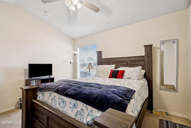 carpeted bedroom with vaulted ceiling, a textured ceiling, and ceiling fan