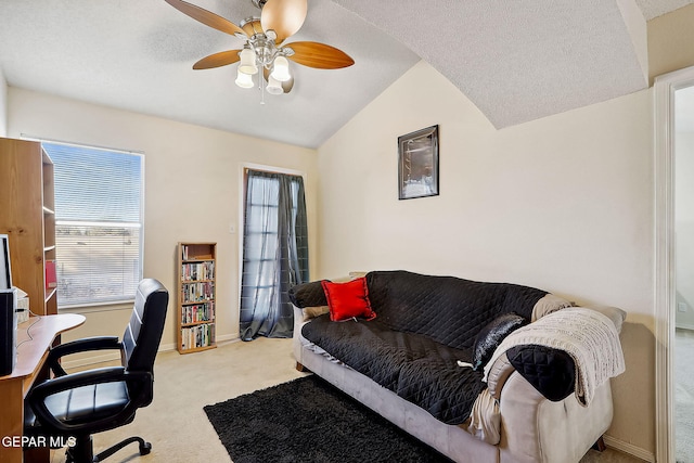 office area with lofted ceiling, a textured ceiling, light carpet, and ceiling fan