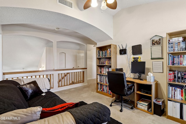 office featuring vaulted ceiling, light colored carpet, and ceiling fan