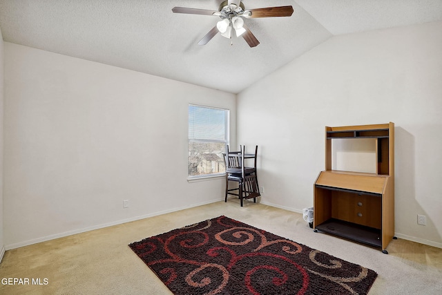 interior space with vaulted ceiling, light colored carpet, a textured ceiling, and ceiling fan