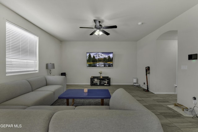 tiled living room featuring ceiling fan