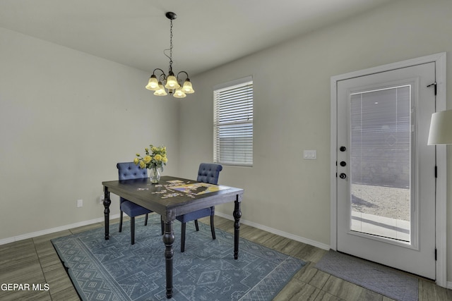 dining room with hardwood / wood-style flooring and a notable chandelier