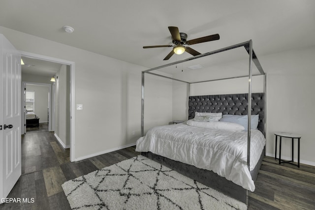 bedroom with dark hardwood / wood-style floors and ceiling fan