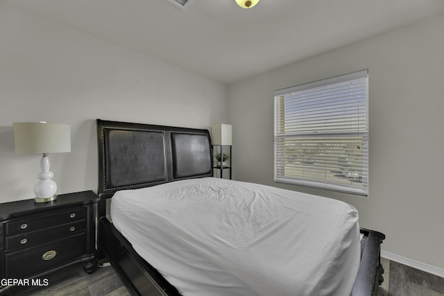 bedroom with dark wood-type flooring