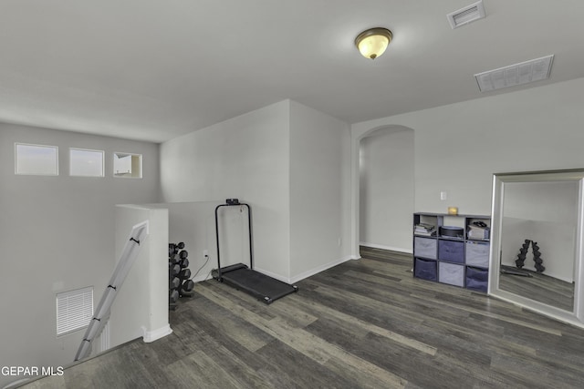 workout area with dark wood-type flooring