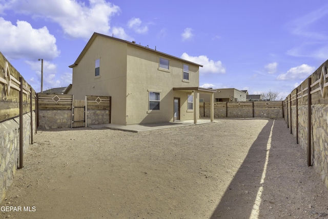 back of property with a patio