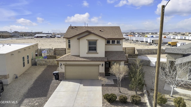 view of front of property with a mountain view and a garage