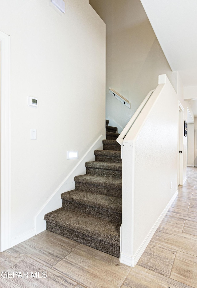 stairway featuring hardwood / wood-style floors