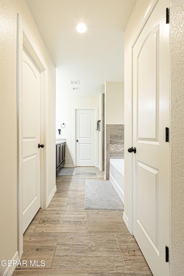 hall with light hardwood / wood-style flooring