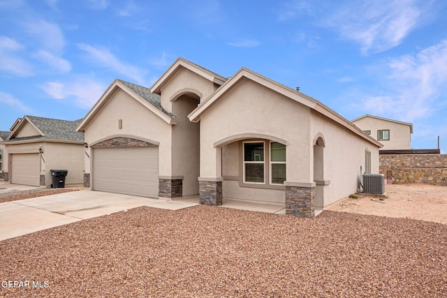 view of front of home featuring a garage and central air condition unit