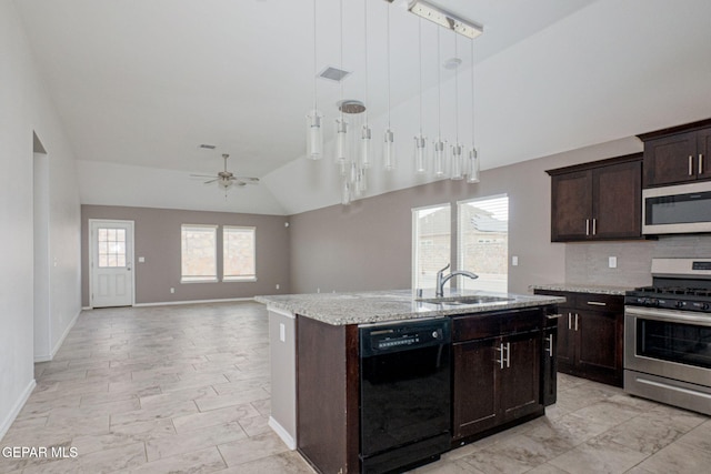 kitchen with lofted ceiling, sink, appliances with stainless steel finishes, dark brown cabinetry, and a center island with sink