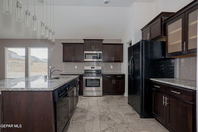 kitchen with light stone counters, dark brown cabinetry, sink, and black appliances