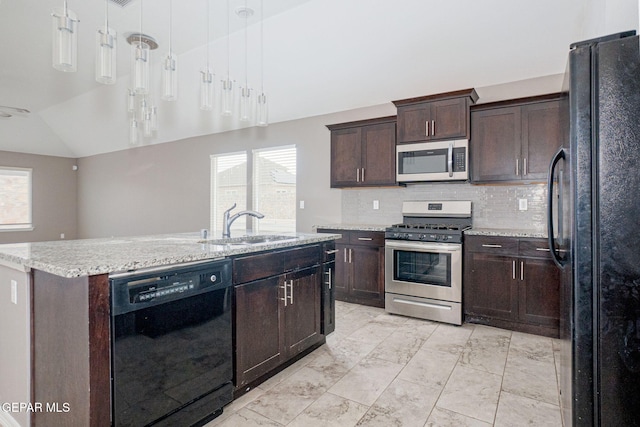 kitchen featuring a kitchen island with sink, hanging light fixtures, a wealth of natural light, and black appliances